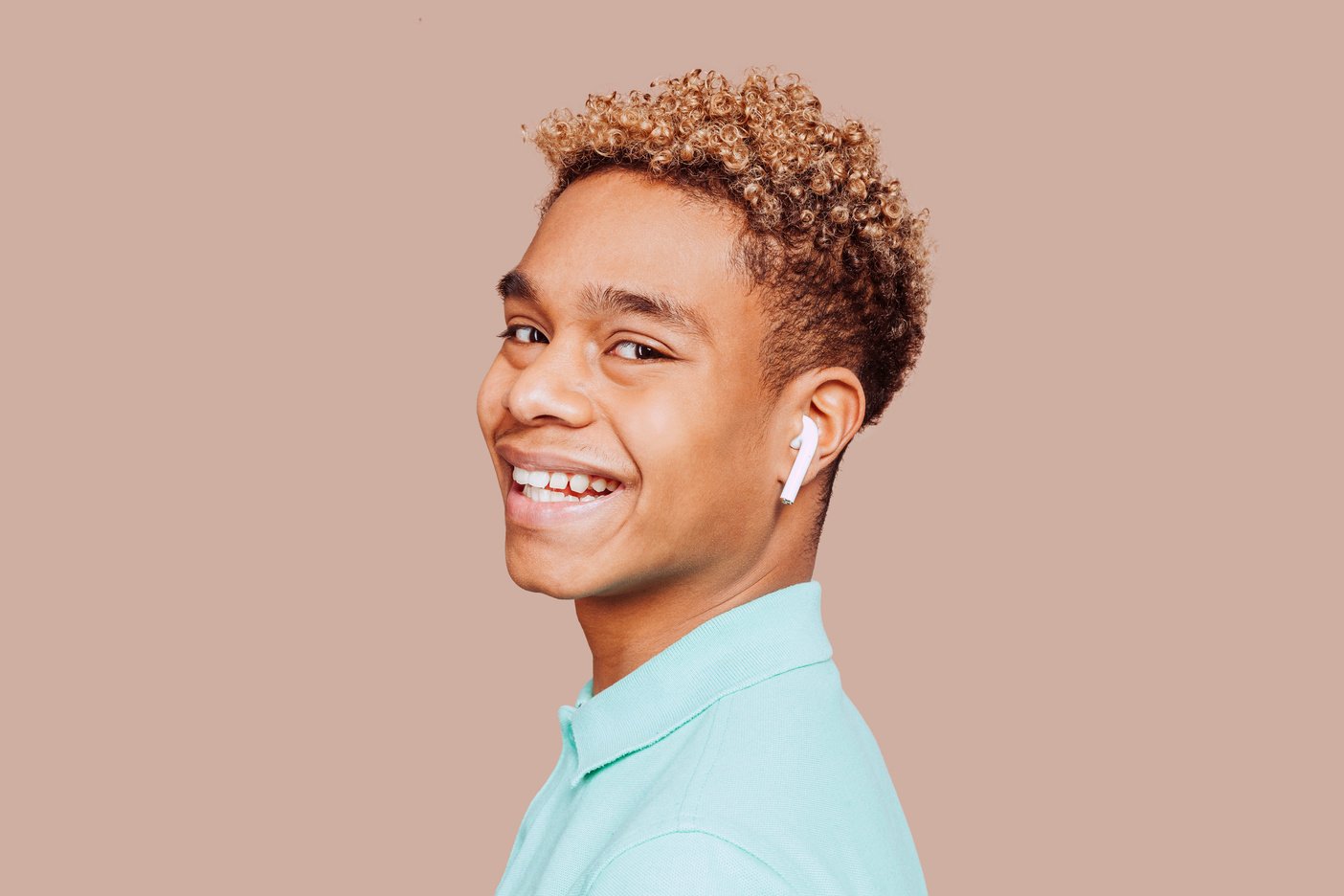 Young afro black latin man listens pocast with earphones